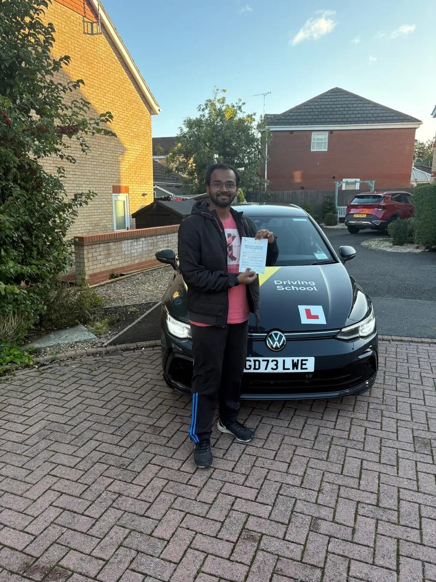 Akshet celebrating with his UK practical driving test pass certificate after lessons with DrivePro Midlands