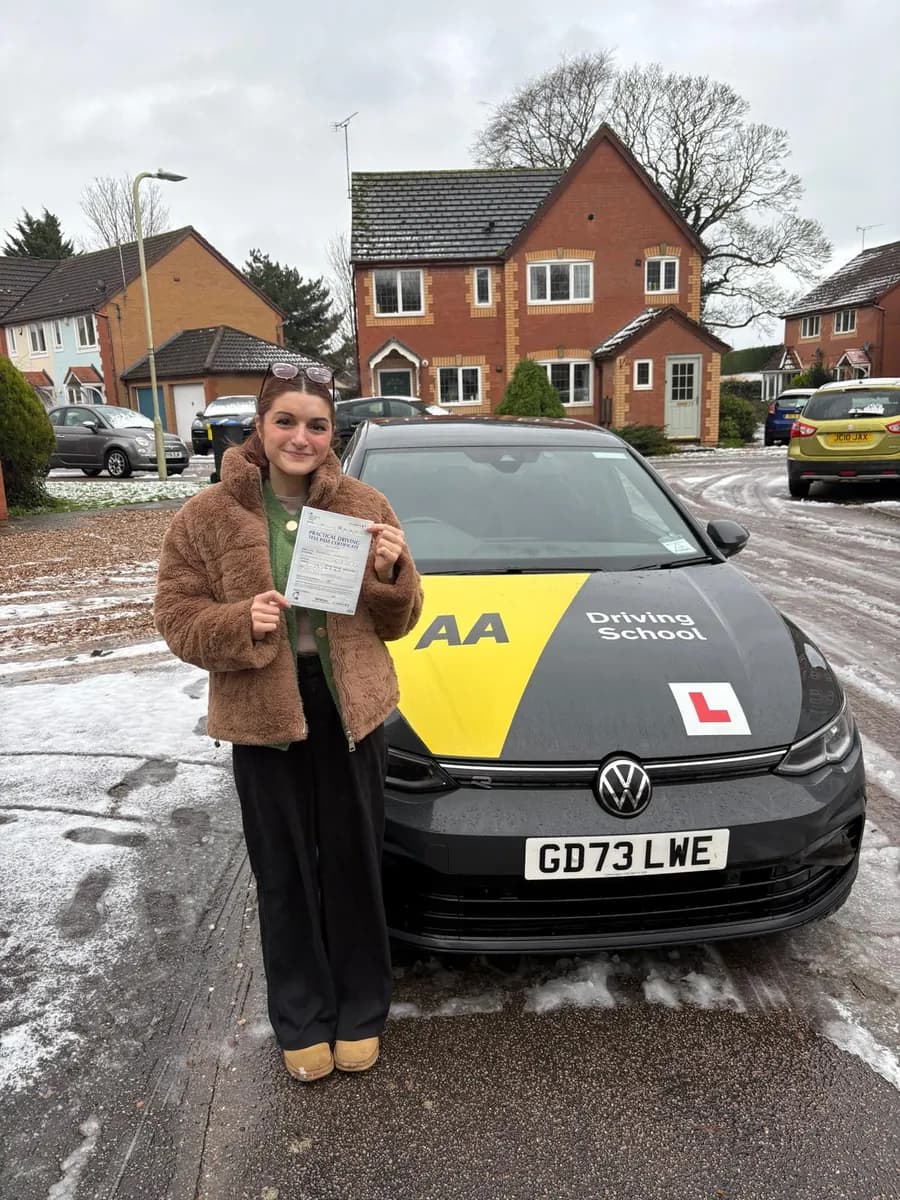 Becky celebrating with her UK practical driving test pass certificate after lessons with DrivePro Midlands