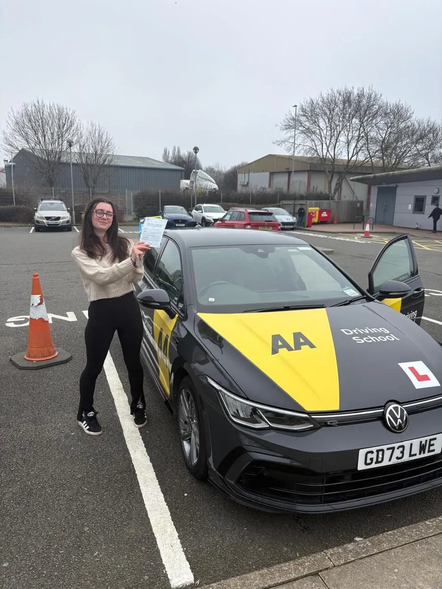 Holli celebrating with her UK practical driving test pass certificate after manual lessons with Maurizio Gobbato at DrivePro Midlands