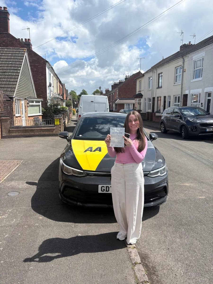 Thayla-Ann celebrating with her UK practical driving test pass certificate after manual lessons with Maurizio Gobbato at DrivePro Midlands